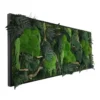 Side view of elongated black frame filled with textured green moss, ferns, and decorative branches