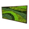 Side perspective of textured mixed green moss wall art inside a dark rectangular wooden frame