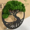 Angled view of round tree wall art with black frame and textured green ball moss canopy
