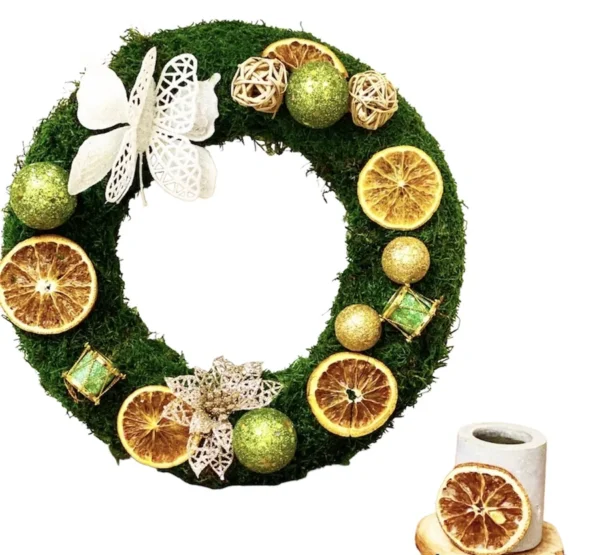 Stabilized moss wreath decorated with dried fruit slices and festive ornaments