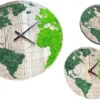 Three round wooden world map clocks with two-tone green preserved moss, displayed from different angles