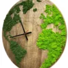Round wooden world map wall clock with dark green and lime green preserved moss continents and black hands.