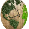Round wooden world map wall clock with dark and bright green preserved moss continents, shown from an angle.