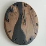 Black Wood and Epoxy Wall Clock with black numbers and red second hand, side view