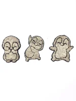 Three penguin wall elements in various poses, crafted from a black contour and light moss.