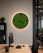 Wall clock with moss and LED on an office wall above a desk with a monitor and office chair.