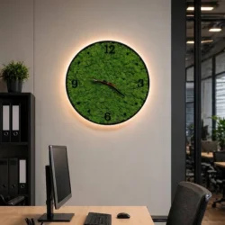 Wall clock with moss and LED on an office wall above a desk with a monitor and office chair.