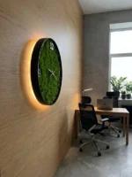 Side view of the wall clock with moss and LED on a wood panel wall in the office with glowing LED backlight.